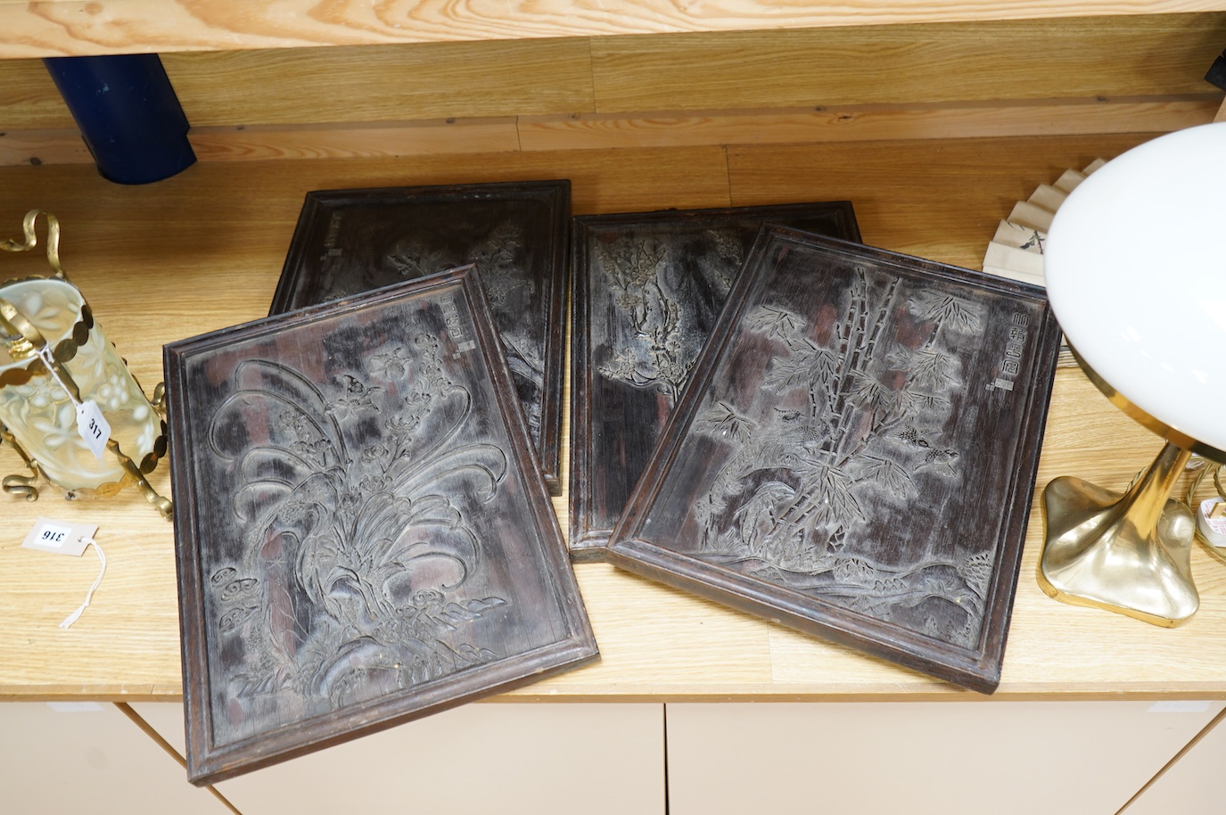 Four Chinese carved bamboo panels decorated with bamboo, trees, birds, etc. 48 x 34.5cm. Condition - fair to good.